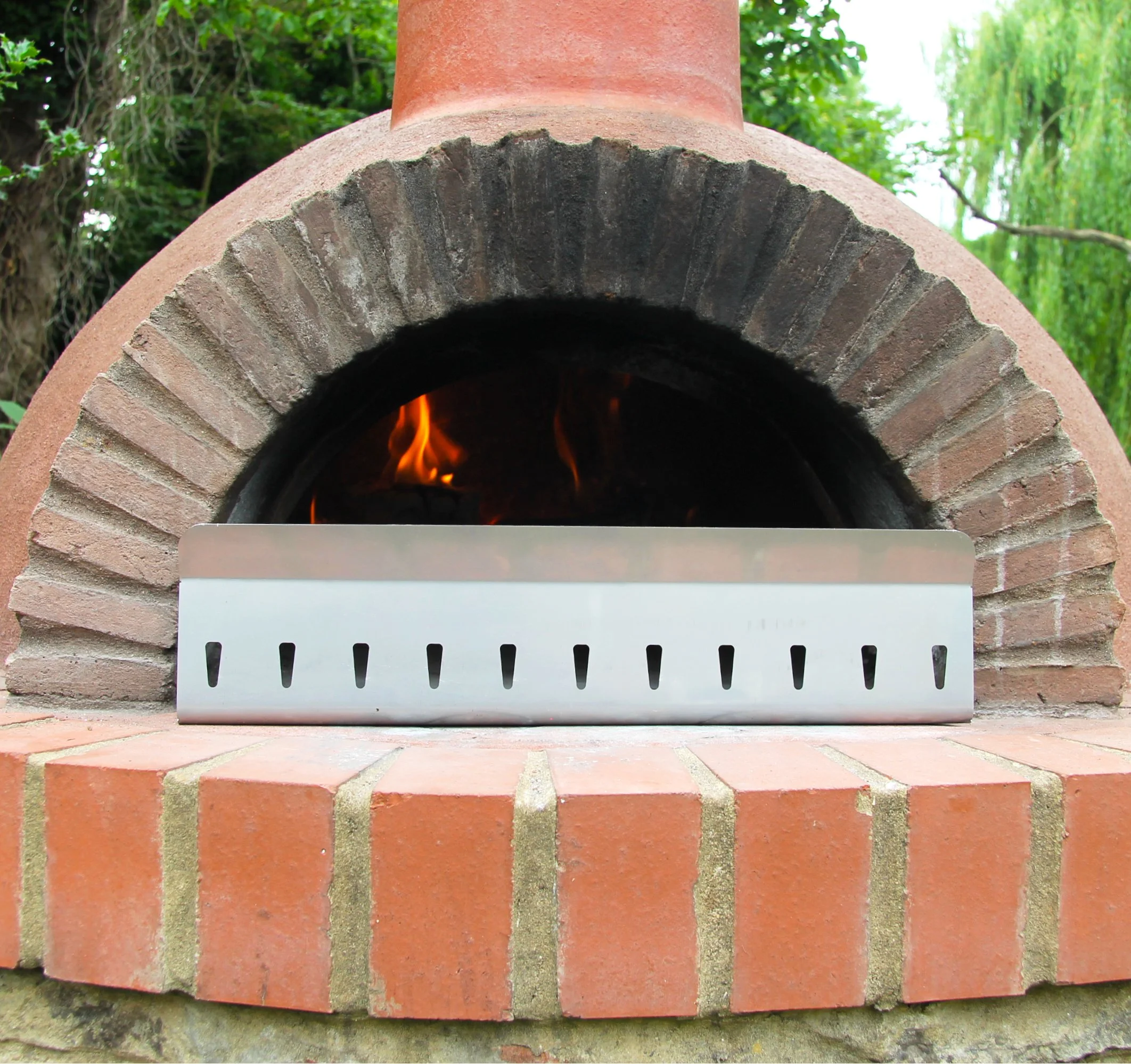 Pizza Fire Guard, Controlling the heat in a pizza oven, cooking in a Pizza Oven Fire Heat Shield with 2 way heat setting feature. Its a great Pizza Oven gift idea for Christmas or birthday.