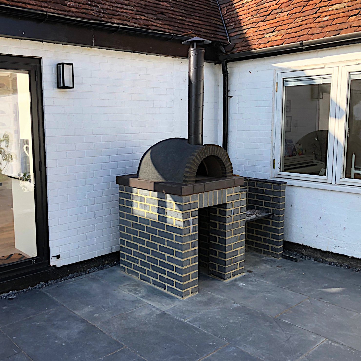 Black themed wood burning pizza oven Oxford.
