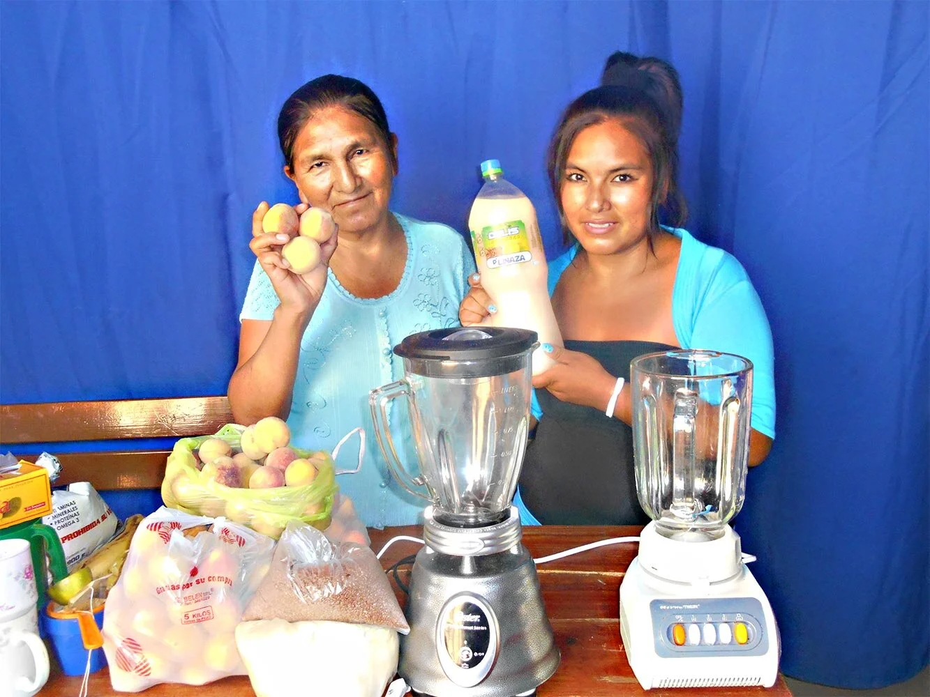 Valentina and her daughter Esther show off their juice business in Bolivia.
