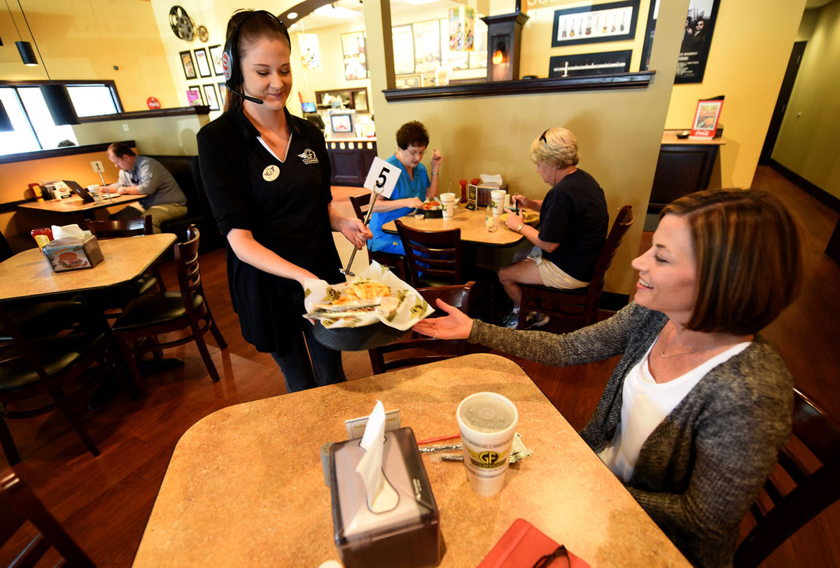 Danny Tindell/ Dothan Eagle / Kyla Grantham with Goldfingersdelivers Mandy Eubanks her order at the restaurant in Dothan on Wednesdday.