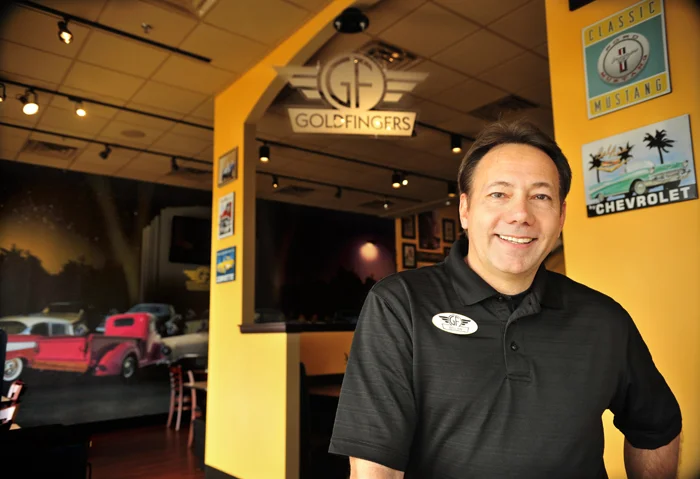 Goldfingers owner Bill Dorminy poses for a photo inside of the Goldfingers restaurant at Cottonwood Corners on Wednesday morning. Jay Hare / Dothan Eagle