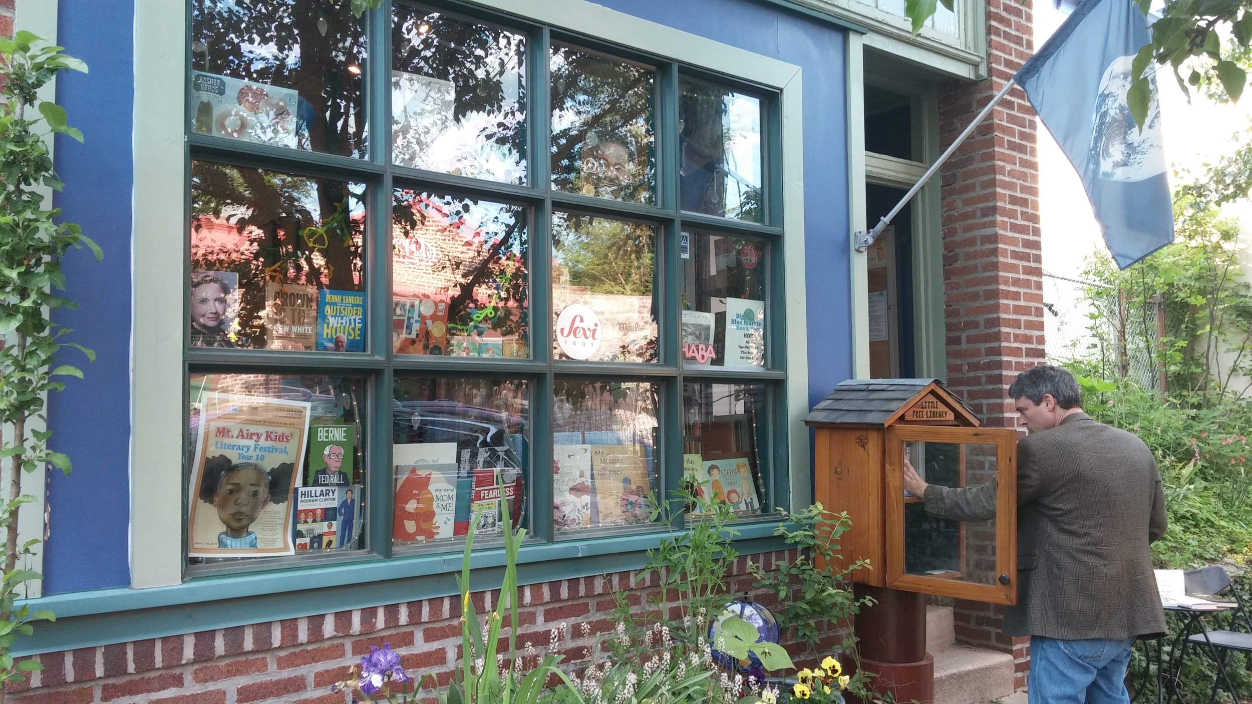 store front with little free library being used.jpg