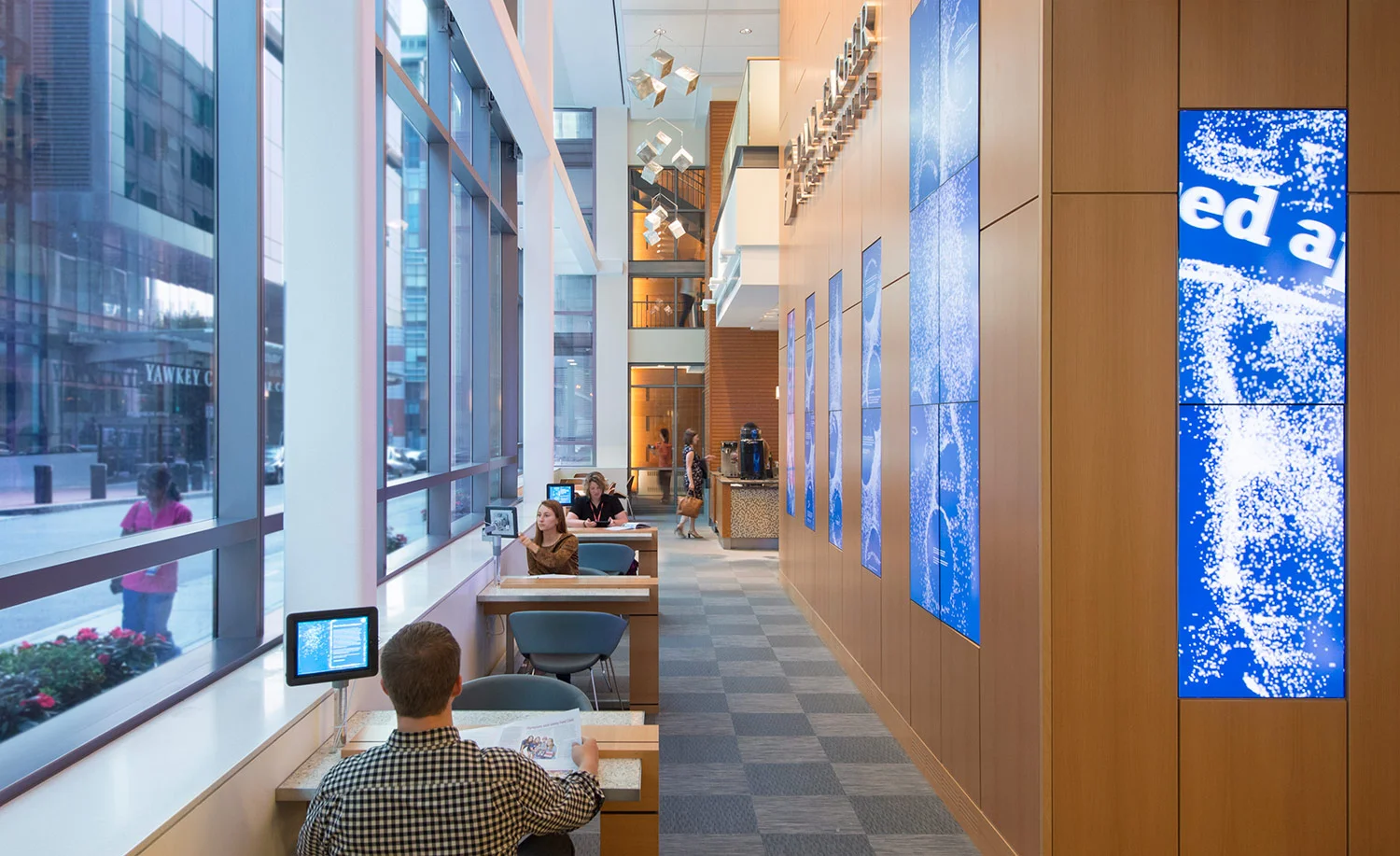 Interactive digital displays in the lobby showcase Dana-Farber Cancer Institute's research, mission and values.