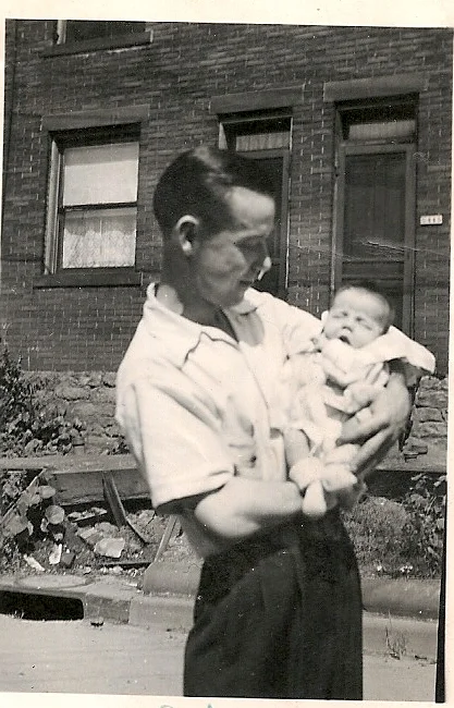 My dad holds me in his arms in 1942.