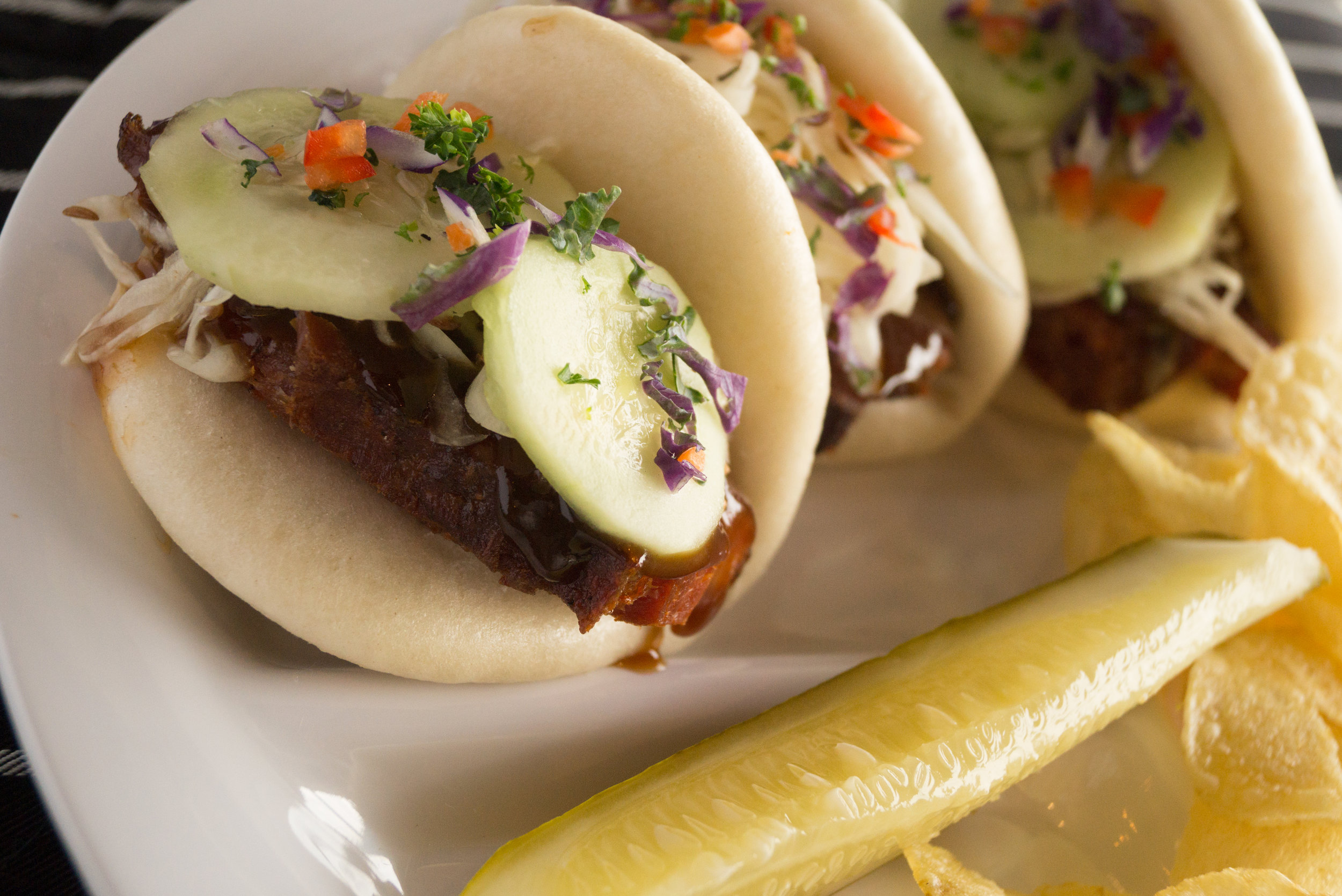 Pork Buns. Pork Belly, cucumber, Asian slaw, sweet hoisin, green onion