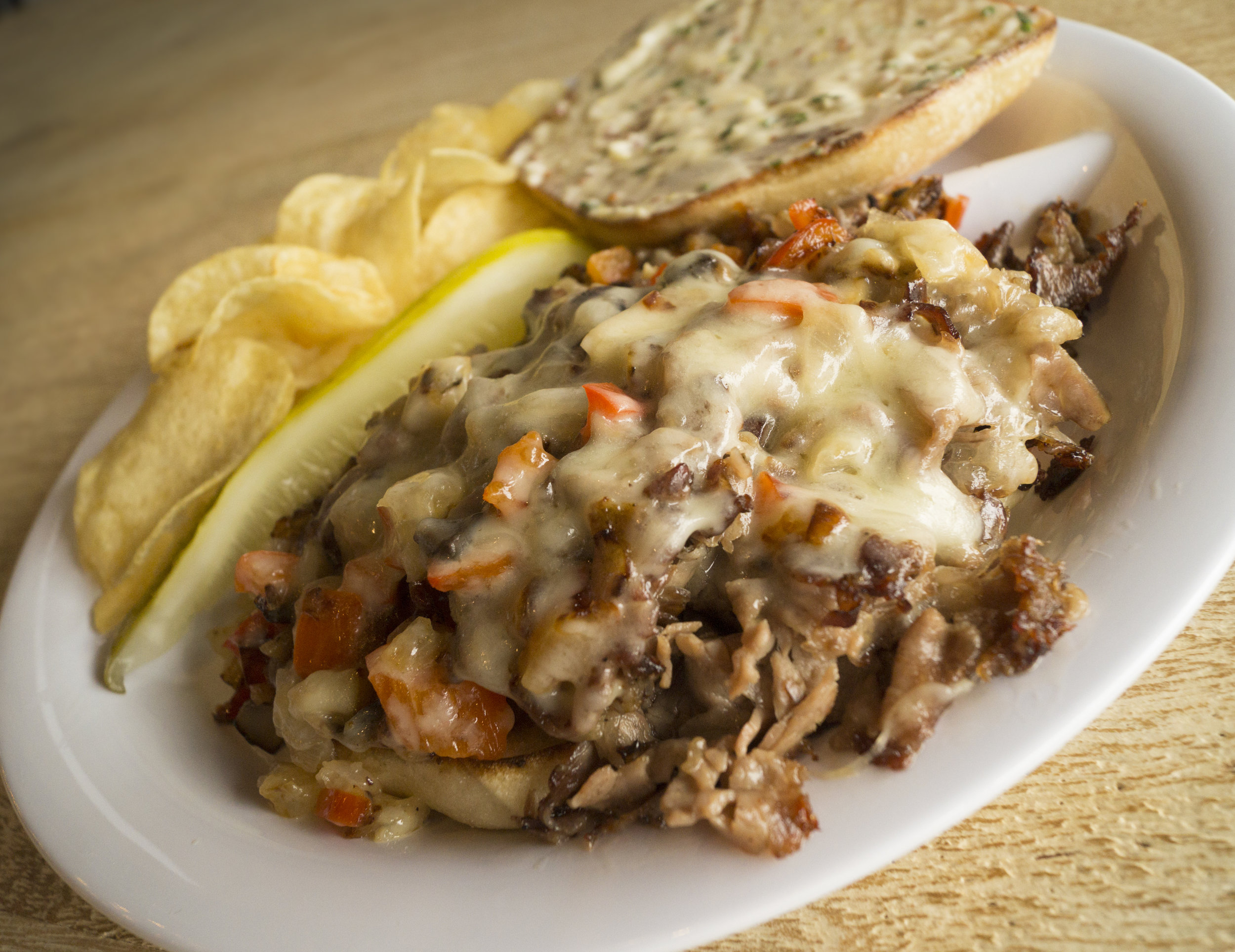 Shaved Steak. Sautéed peppers, onions, mushrooms, american cheese, Mexican roll, chive aioli