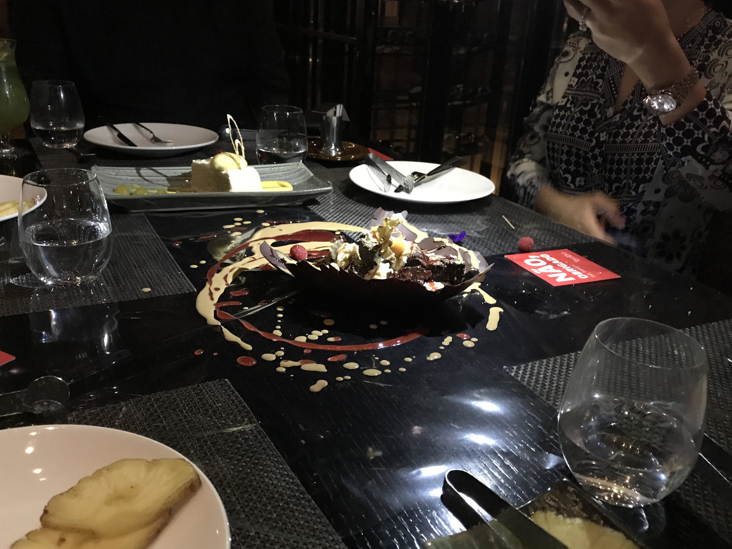  Dessert Bomb. Chocolate Shell with goodies inside dropped on the table 