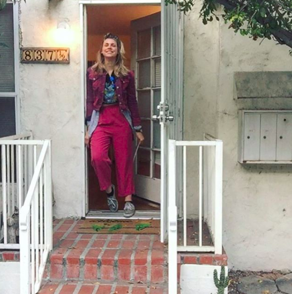 the front steps of my current home, holding a resume, wearing a pink tux, thinking about Shakespeare, about to drink more coffee.