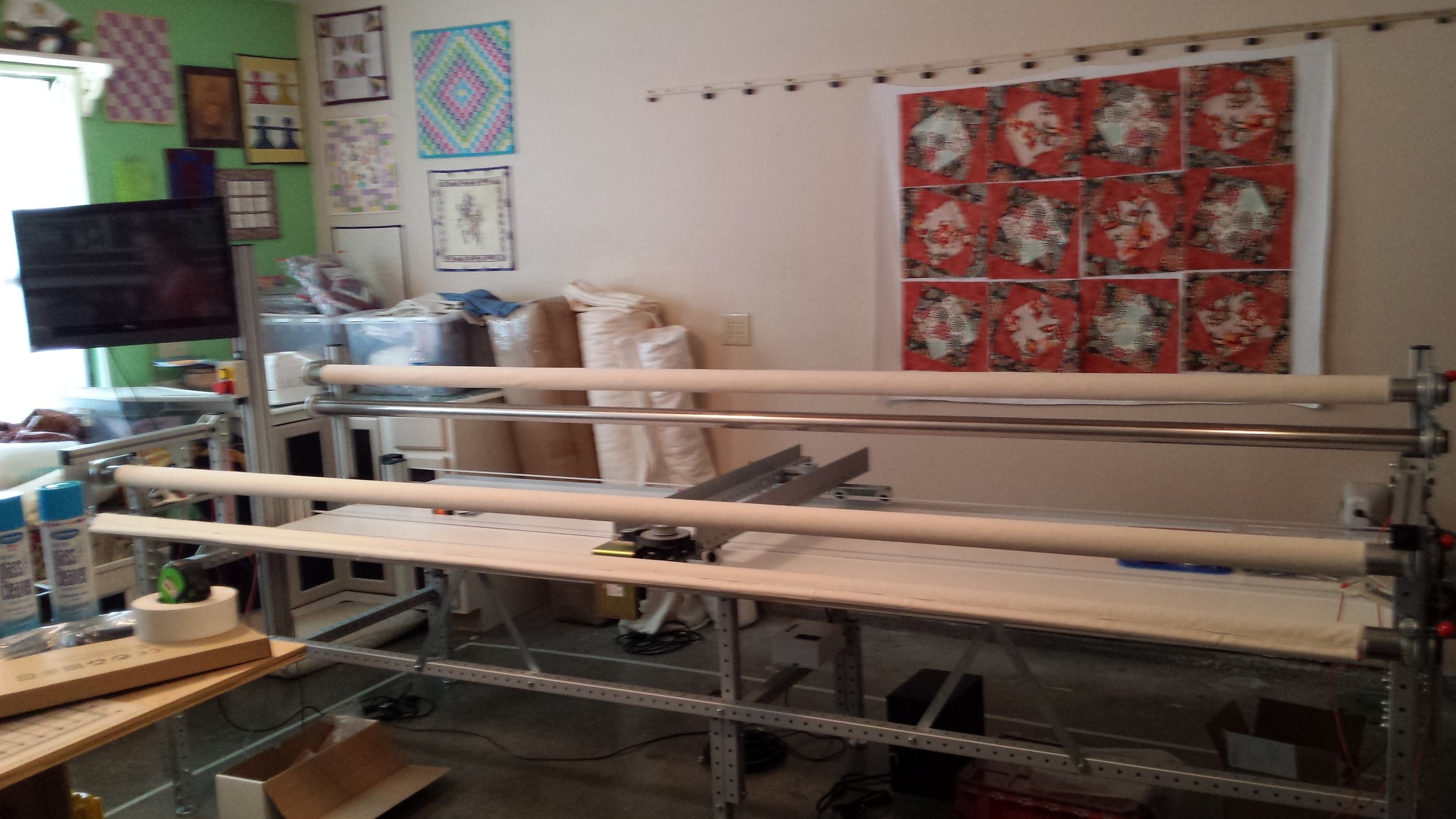 Our Long-arm quilting Machine, and you can see some of our studio.