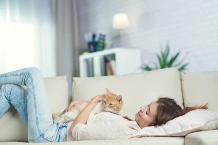 woman lying on sofa with cat.jpg