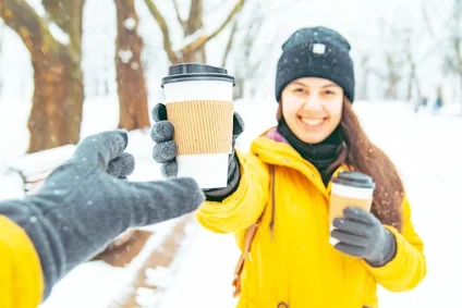 woman handing coffee to friend in snow edited.jpg