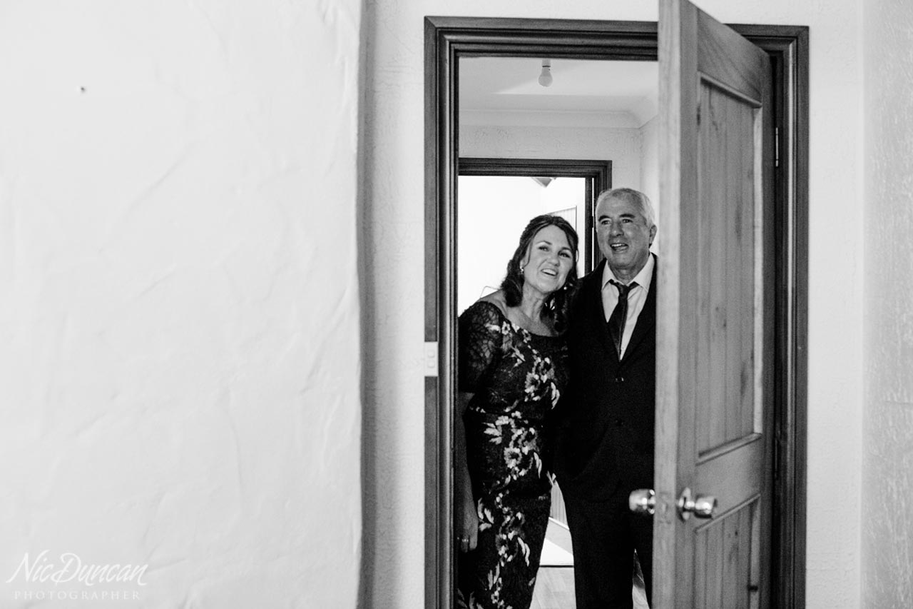 The bride's parents seeing her in her wedding dress for the first time