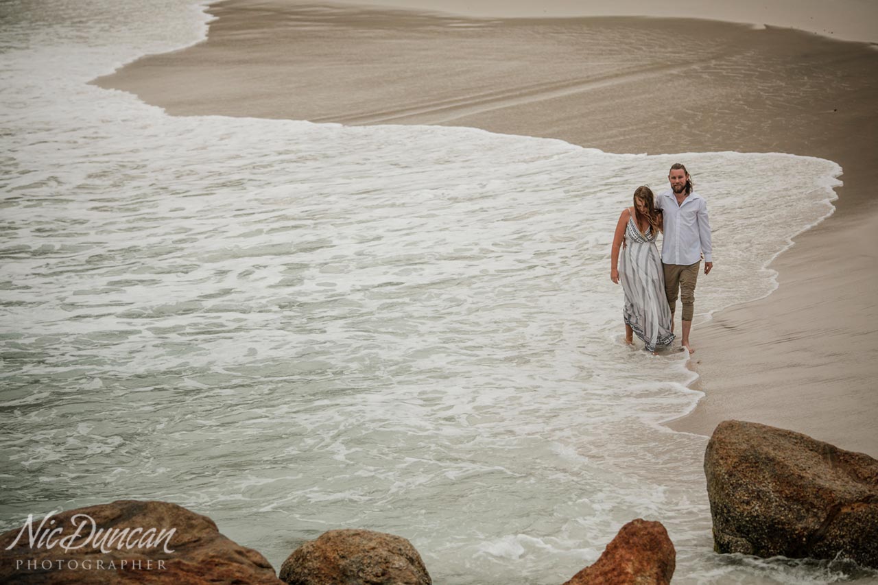 Pre-wedding photo session at Little Beach, playing in the waves