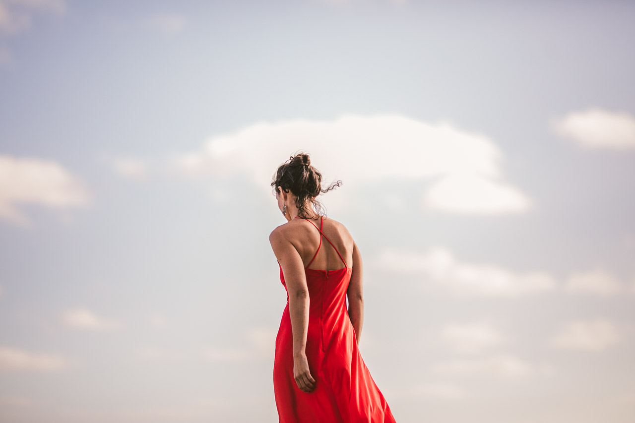 Fire meets sky, red dress and blue sky with clouds