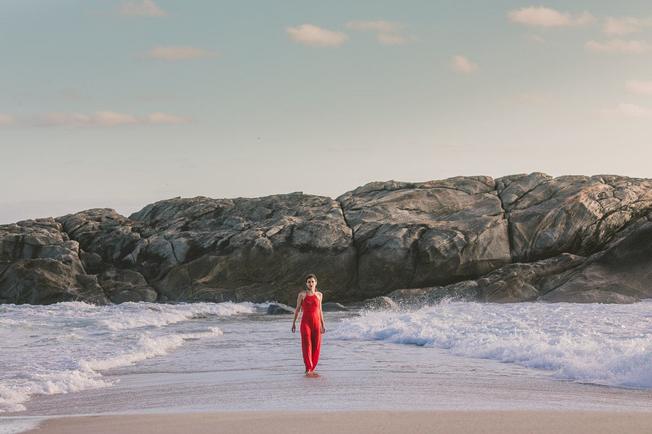Parting the water, red dress, waves and ocean portrait