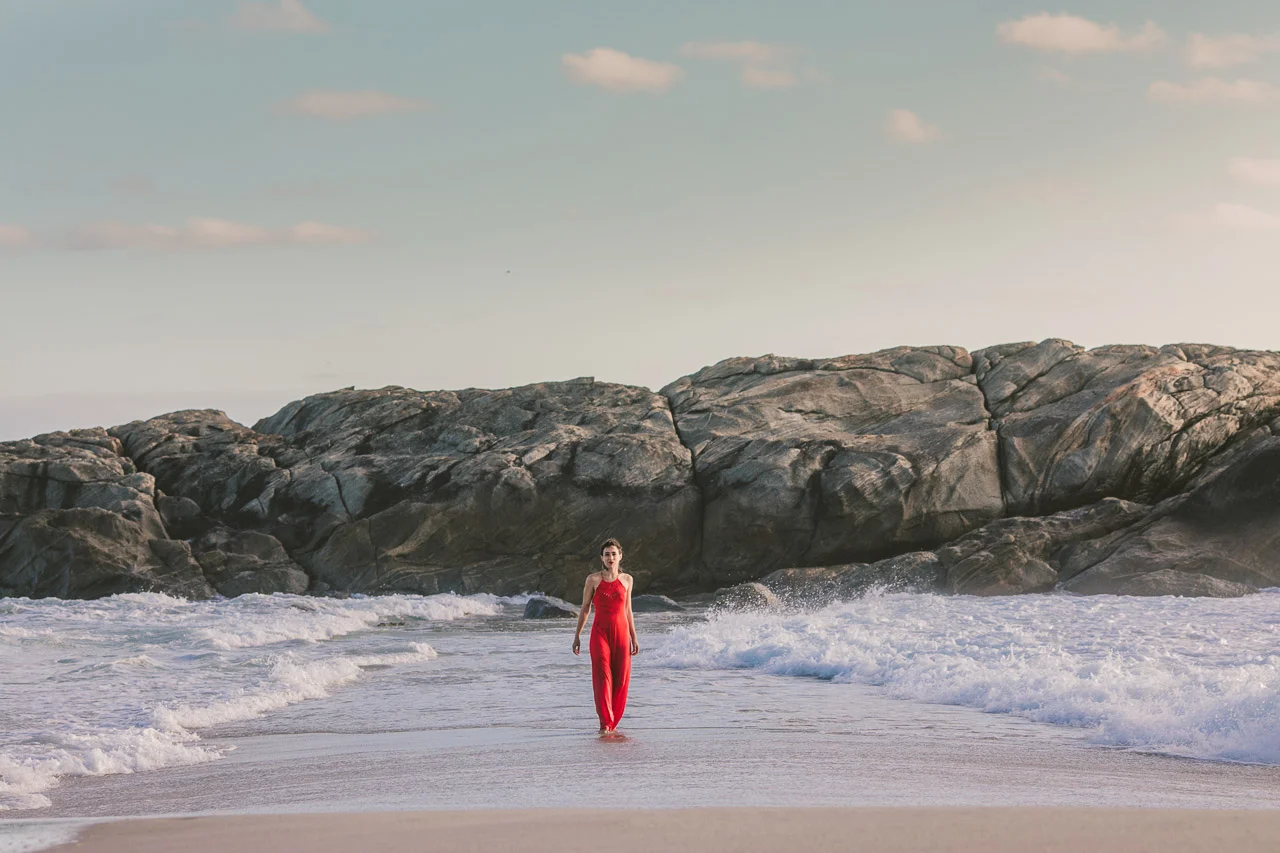 Parting the water, red dress, waves and ocean portrait