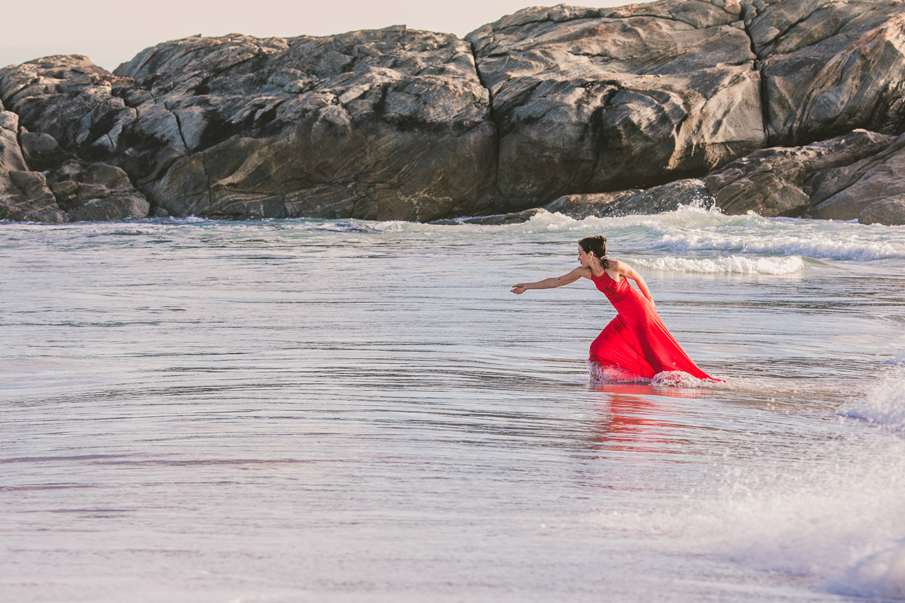 Portrait of a lady in red dress in the ocean, 