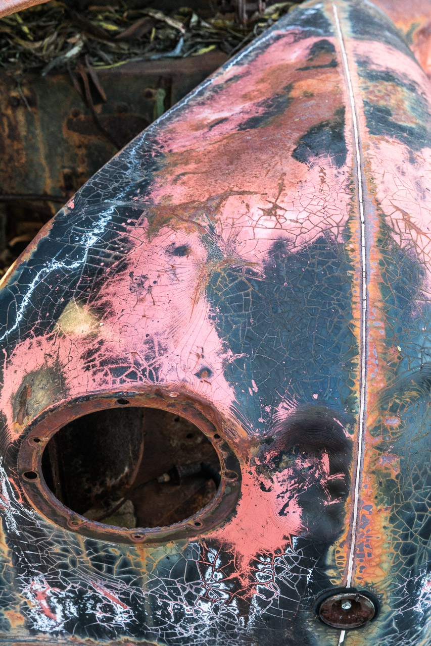 Textures and patterns in the rusted paintwork of an old Austin car