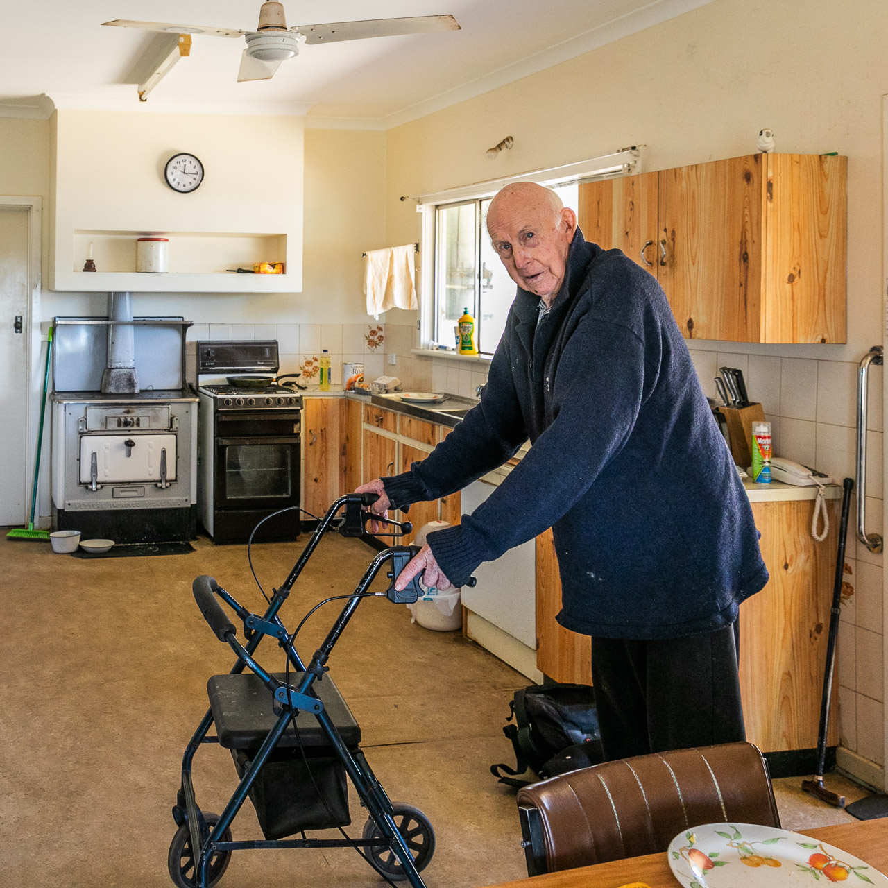 Elderly man in his farm kitchen with his walking frame