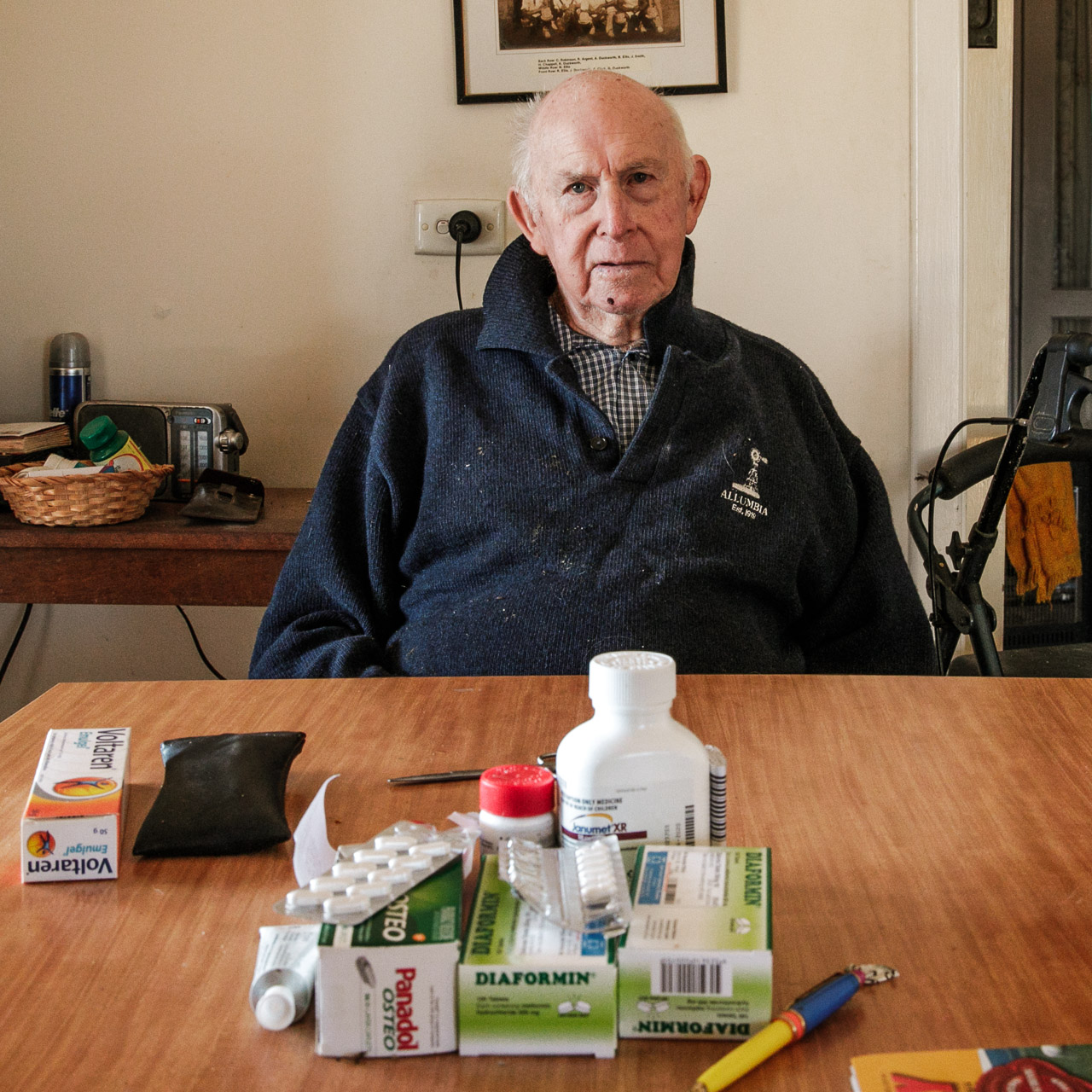 Elderly man at his dining table with his medication