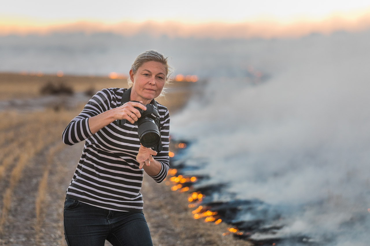 Bruce Rock photographer and farmer, De Strange during windrow burning