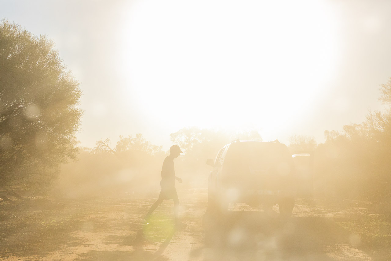 Silhouette of a person and dust and sunset in the Australian outback