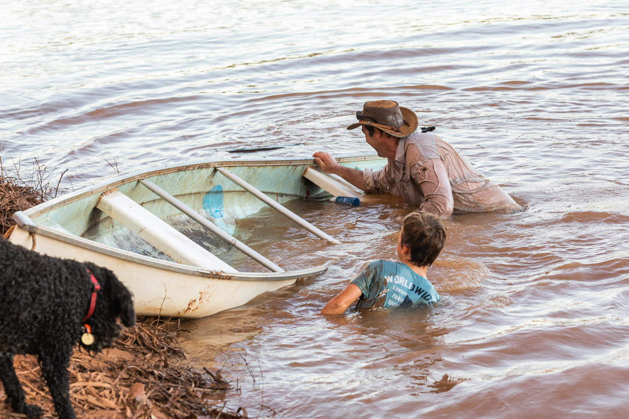 Upturned canoe and wet people
