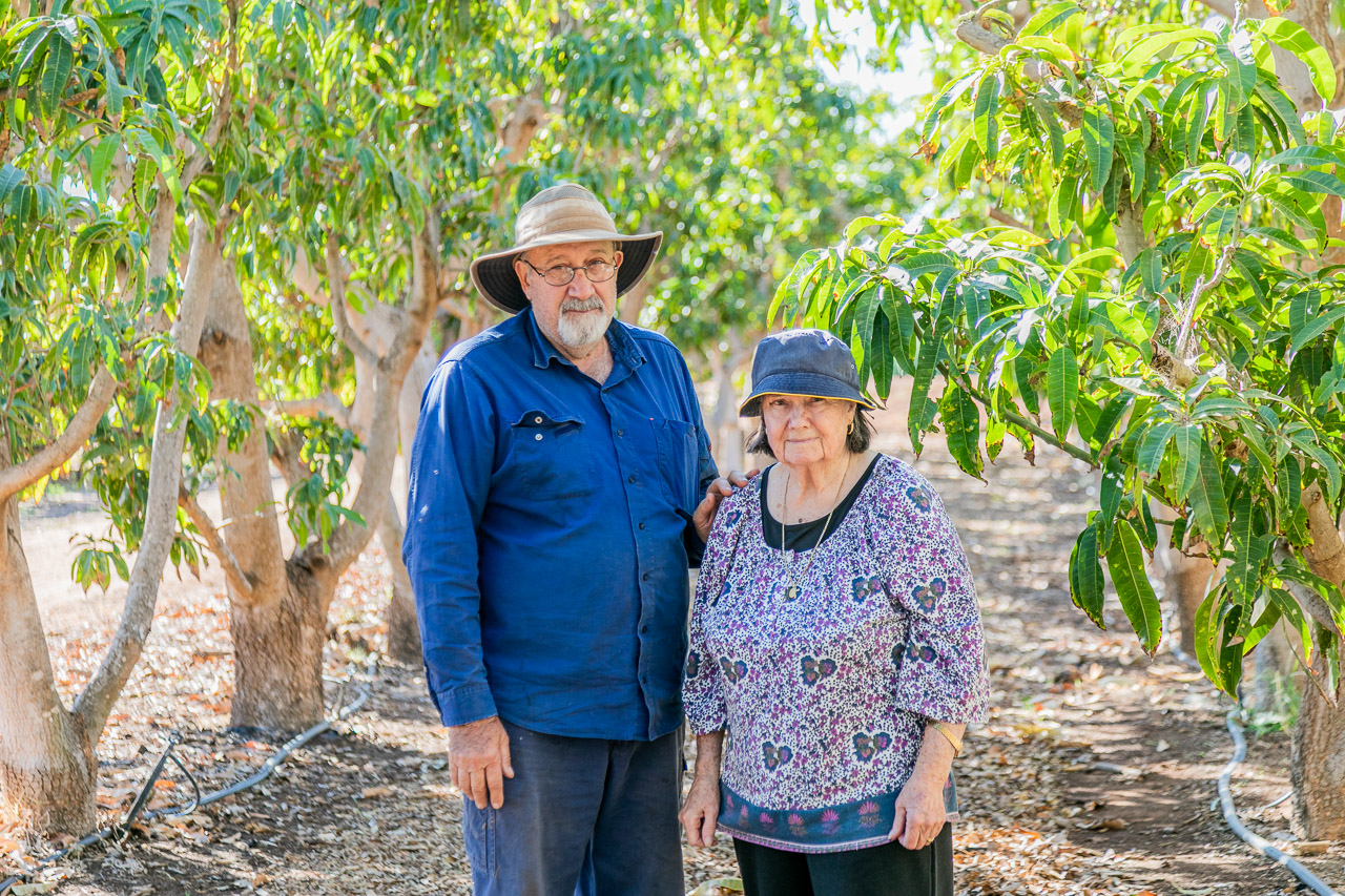 Growers Rick and his mother Zarka in a row of mango trees at their Carnarvon property