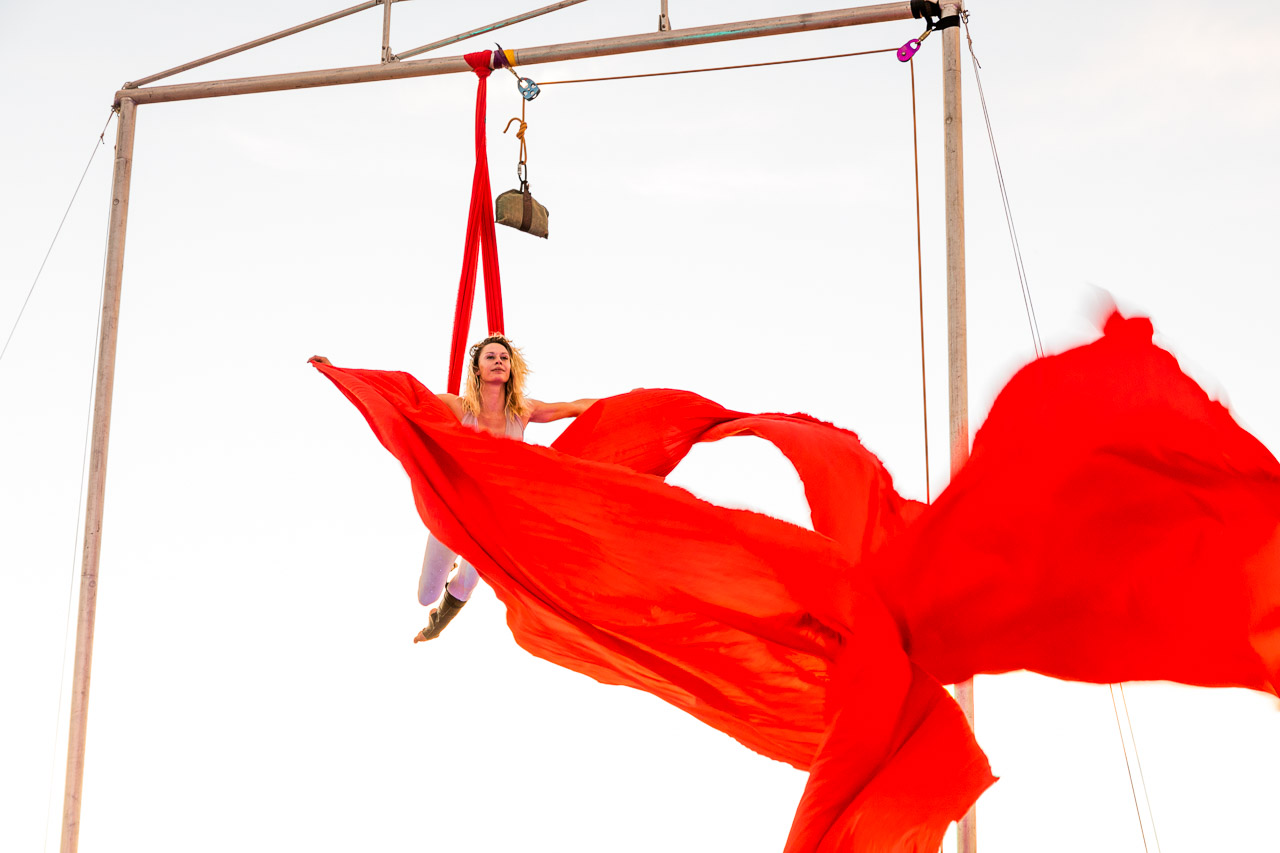 Red silks flying in the breeze - Jade Mills rehearses for her aerial performance