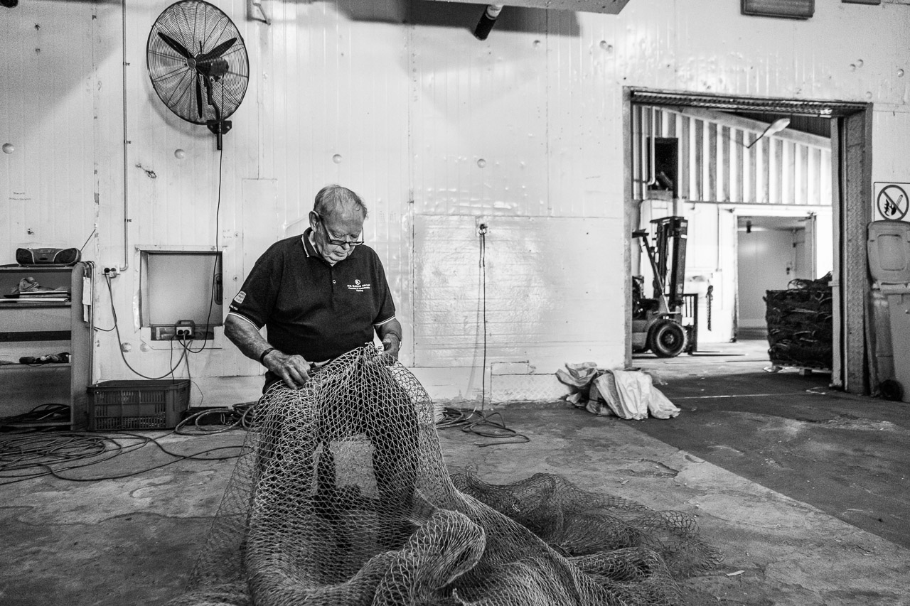 Fixing up holes in prawn nets at MG Kailis, Exmouth