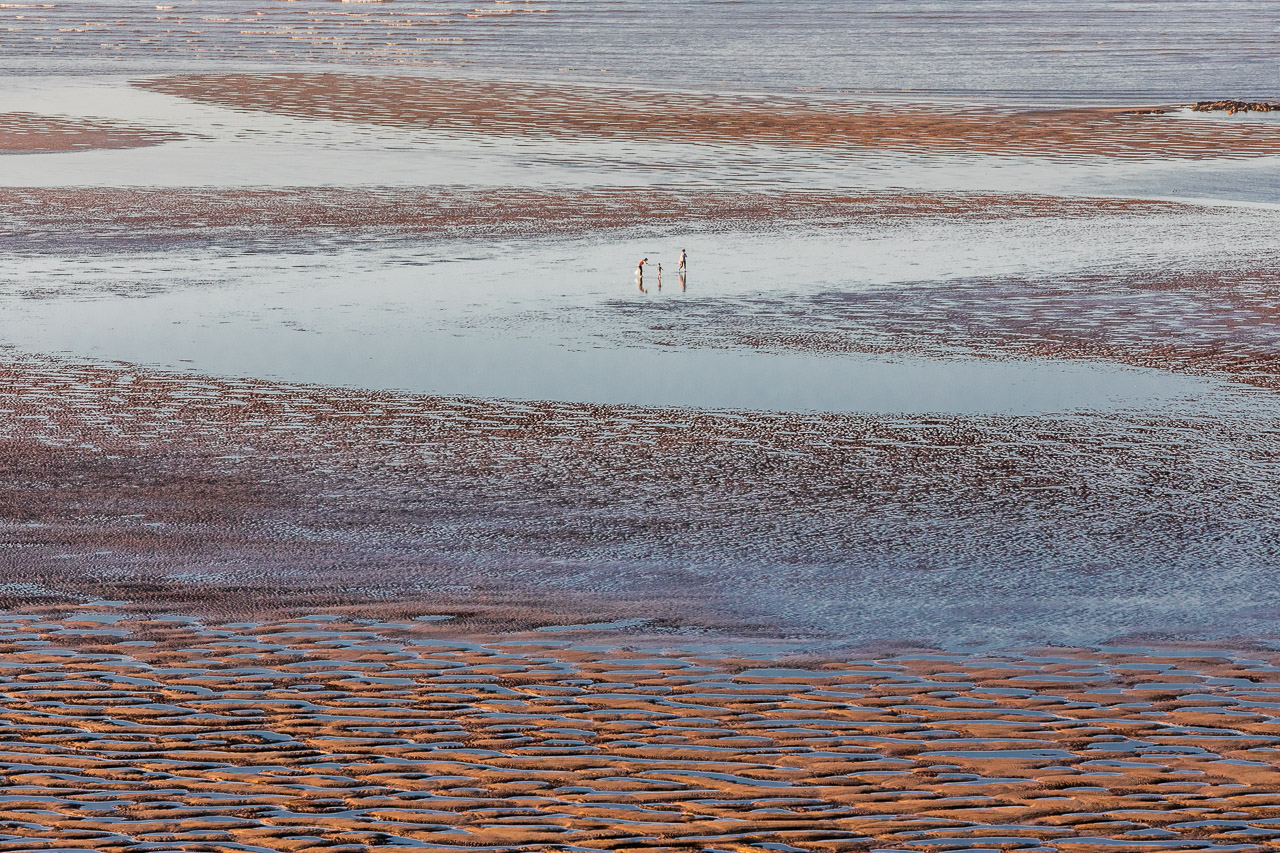 People and sand patterns in Cossack at low tide