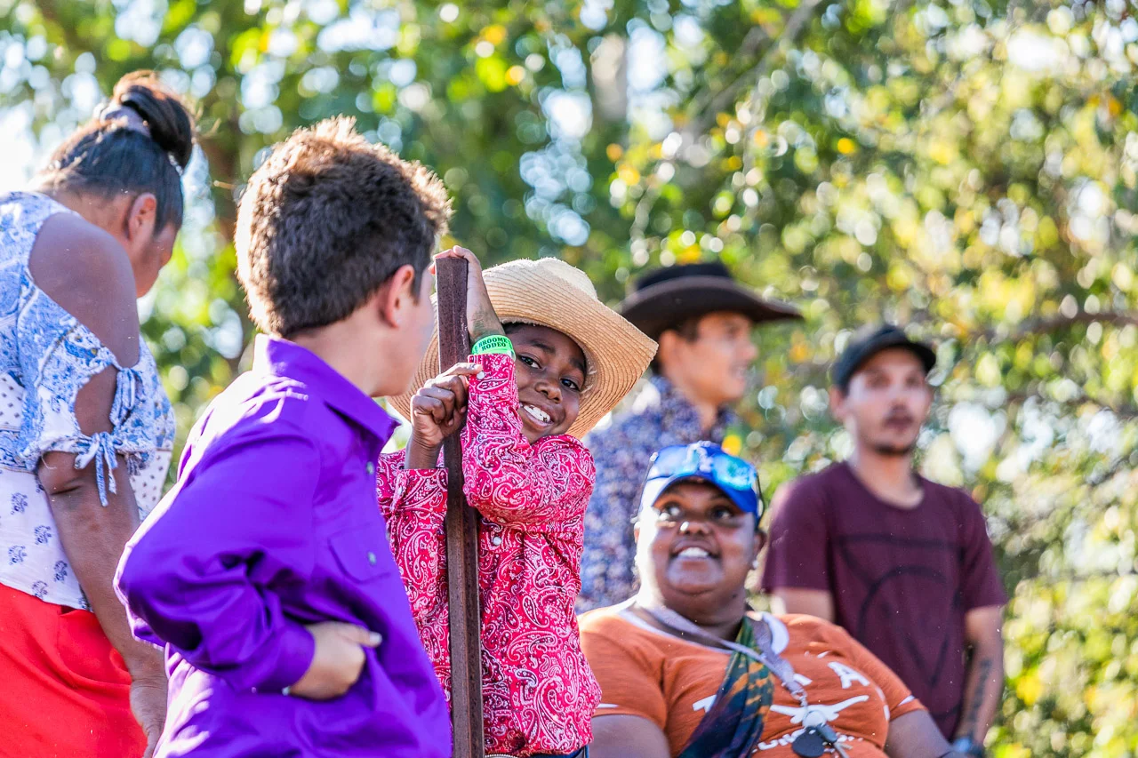 Cute Aboriginal boy in a cowboy hat with his family