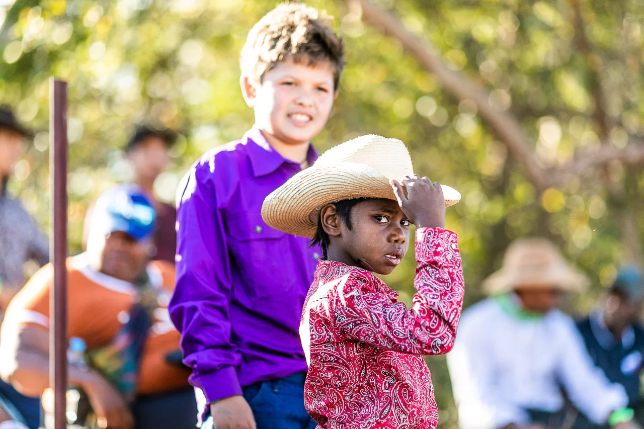 Aboriginal boy in a cowboy hat looking at the camera