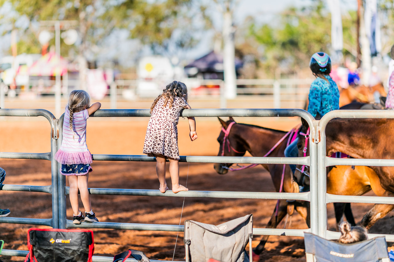 Small kids on the arena fence at the Broome Rodeo