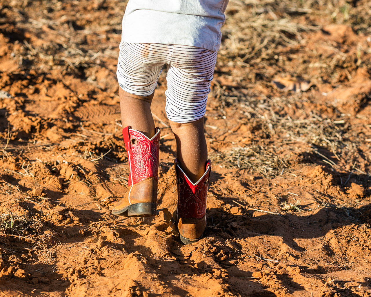 Red cowboy boots in the red dust at the Broome Rodeo