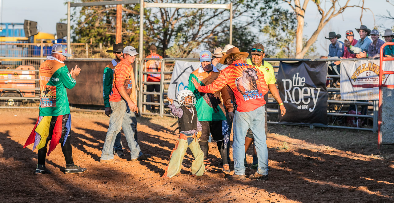High-fives and congratulations for a young rodeo rider