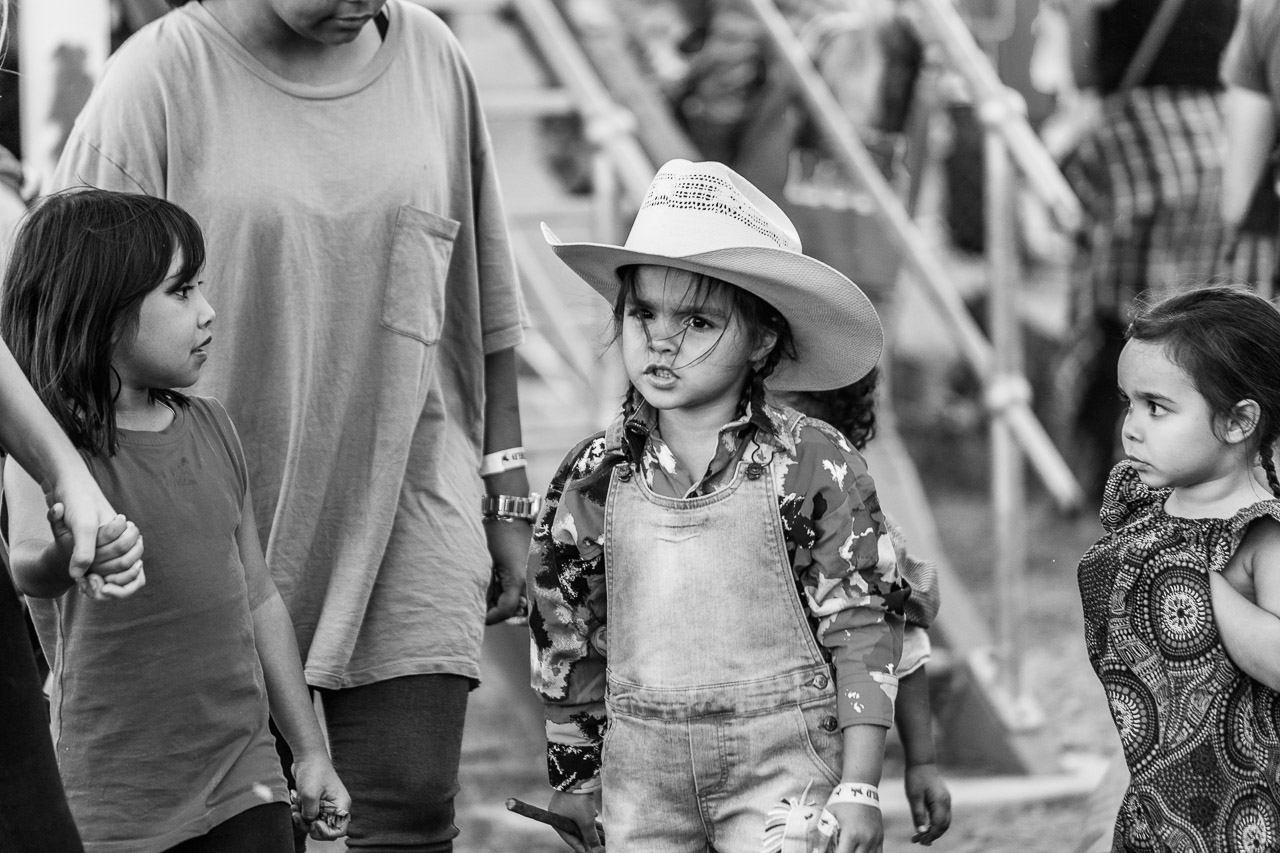 Young girl with a cowboy hat and some serious attitude is watched by her friends - Broome Rodeo 2019