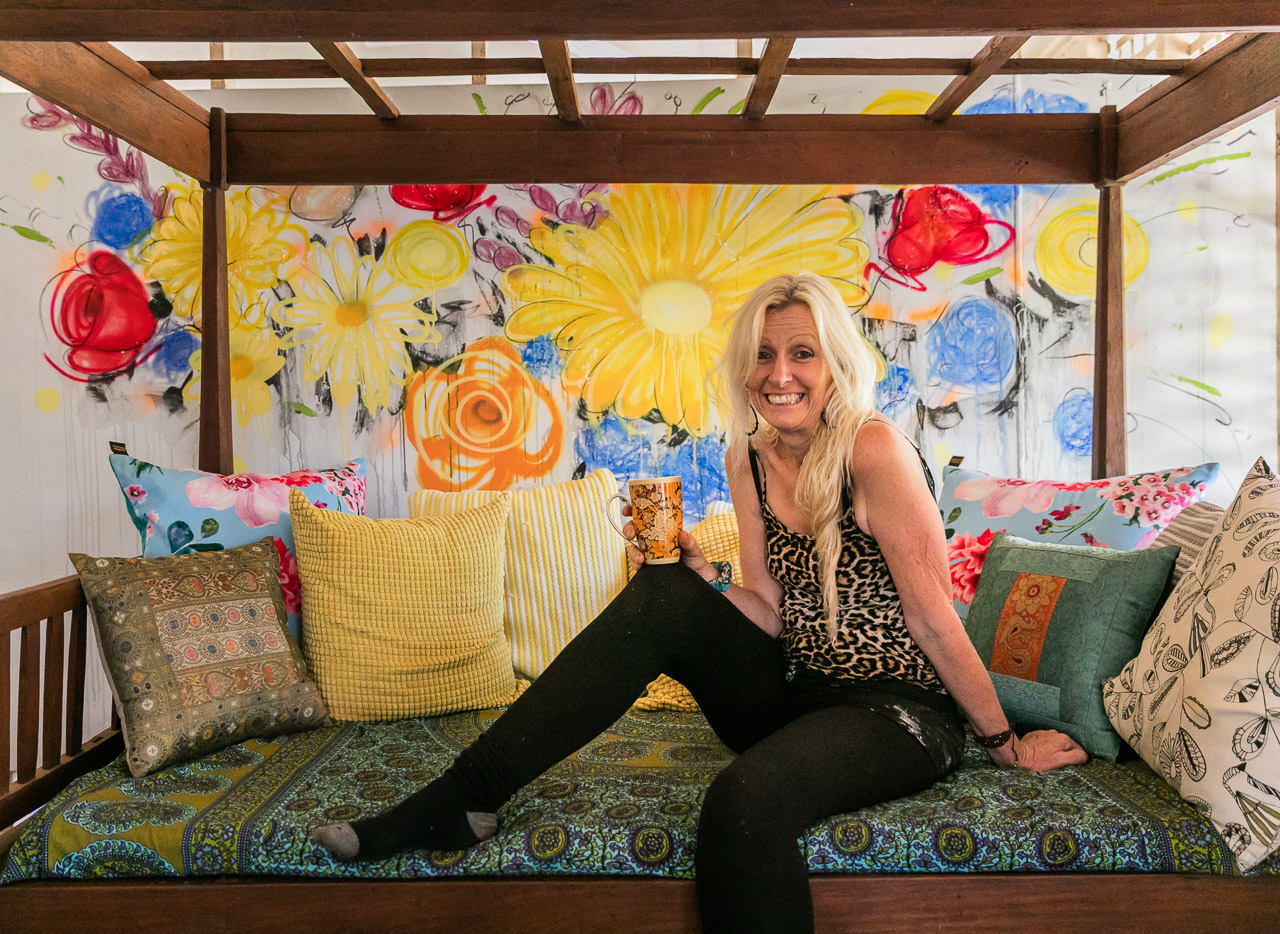 Artist Sobrane Simcock at the Broome home in front of a freshly painted mural