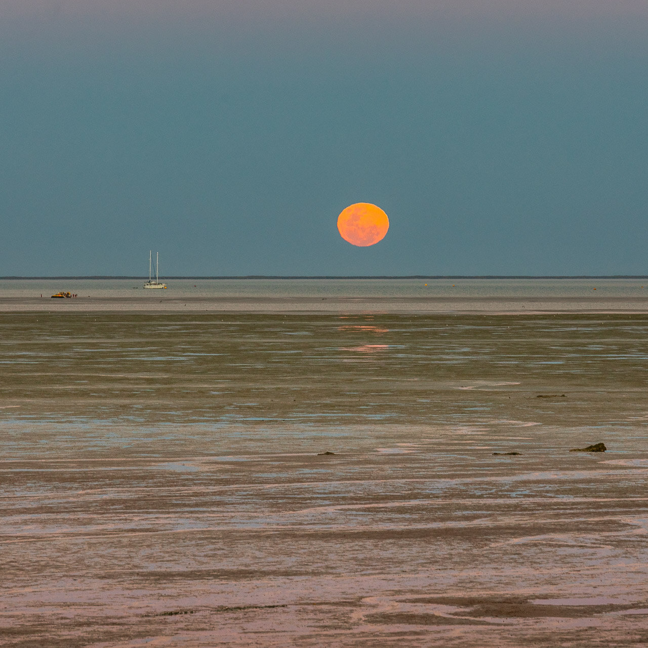 The moon rising over the tidal flat at Town Beach in Broome