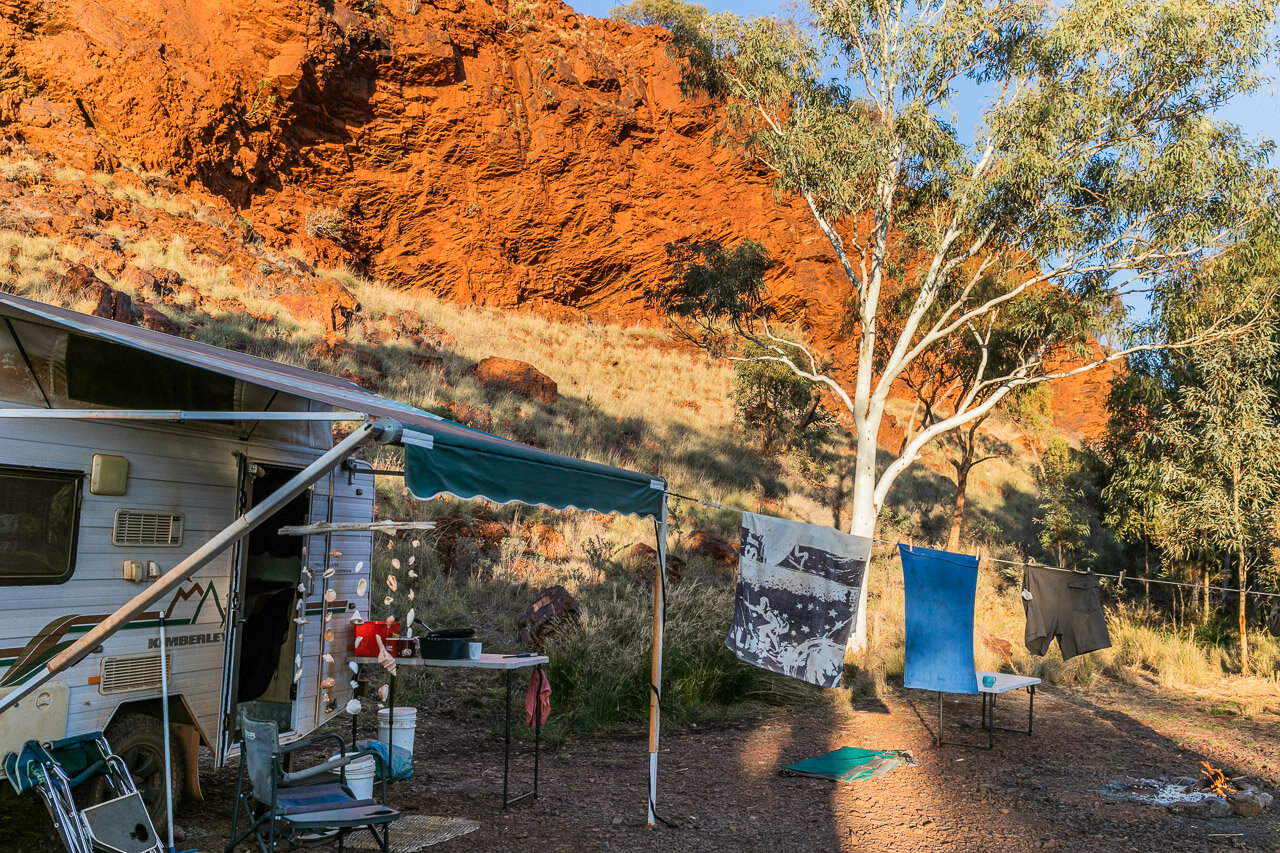 A secluded bush camp nestled in to the red rock cliff face
