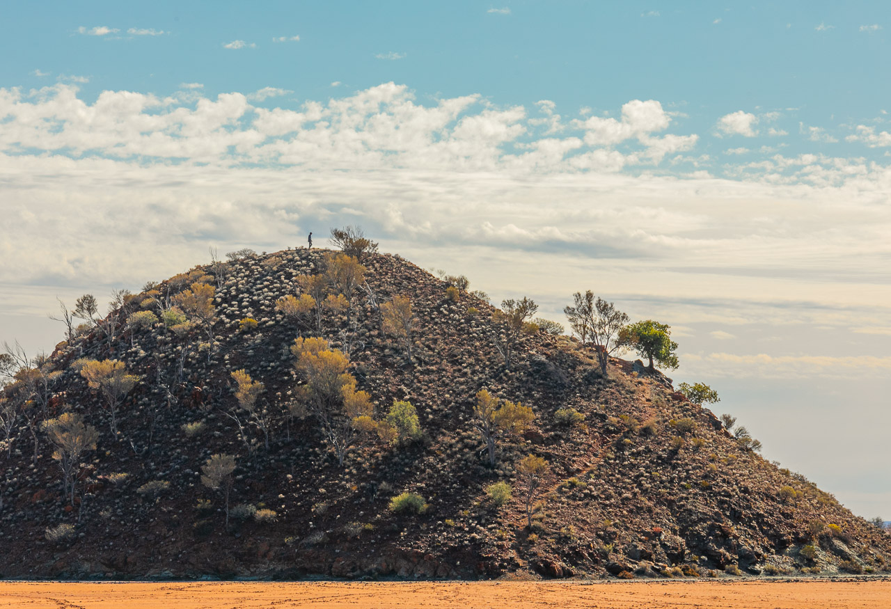 A man silhouetted on the hill at Lake Ballard