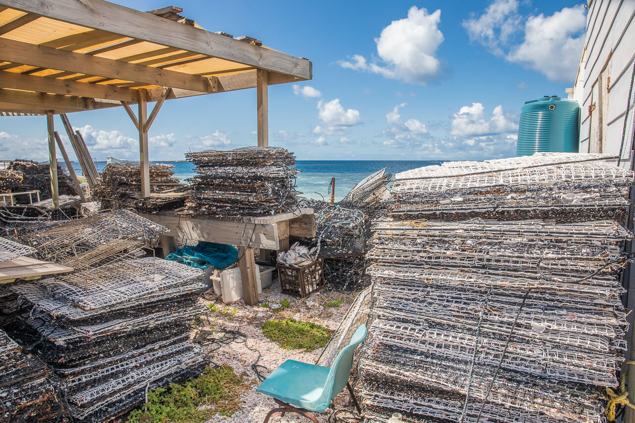 Behind the scenes of the pearl farm with stack of panels on which to grow pearl oysters