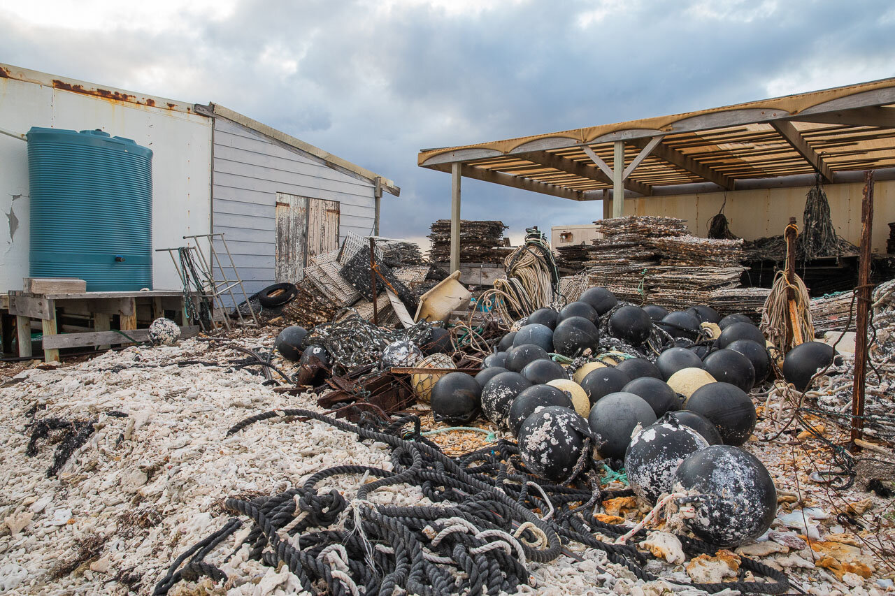 Buoys, ropes and metal panels behind the pearl farm sheds