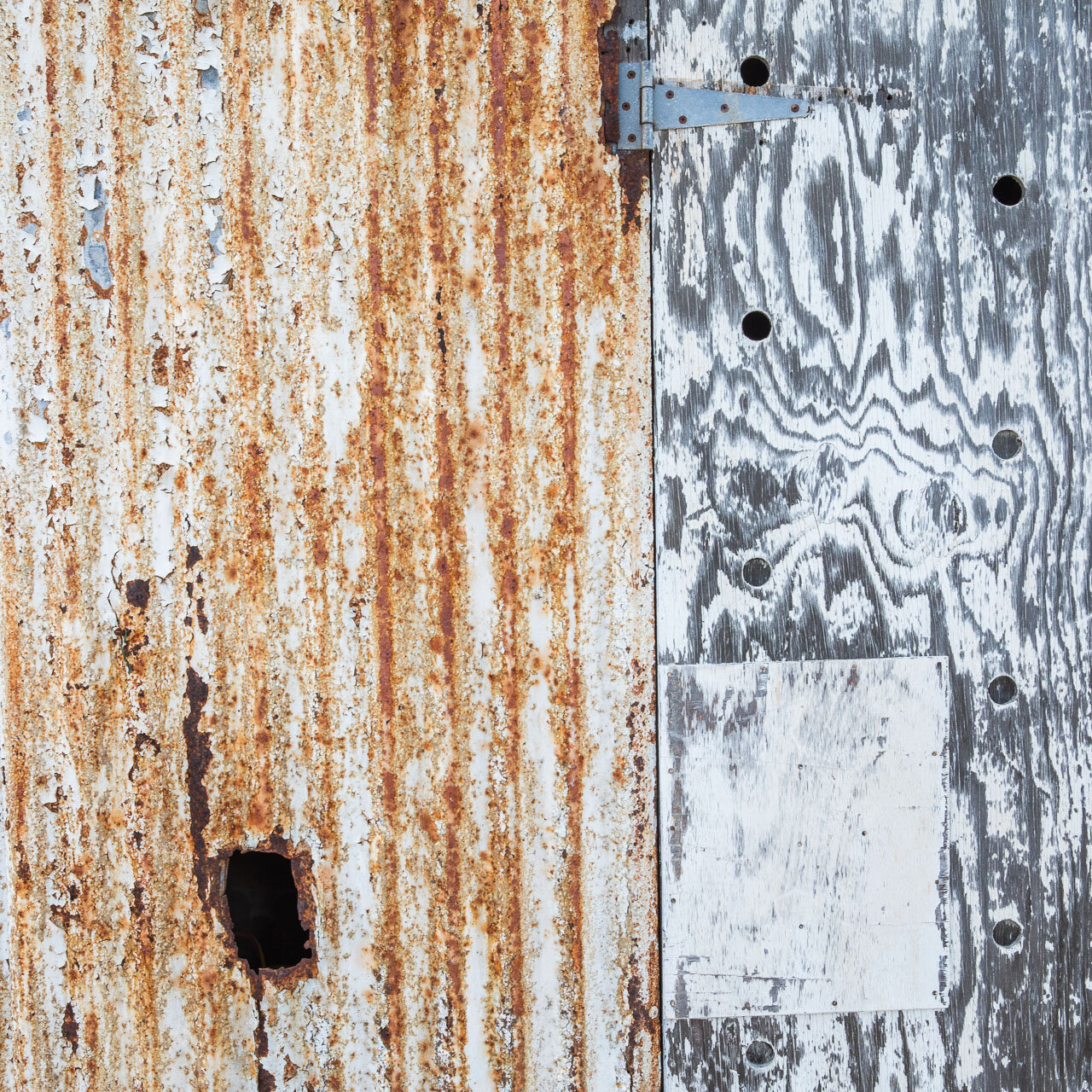 Textures in metal and rust, wood and paint on the outside of an Abrolhos Islands shack