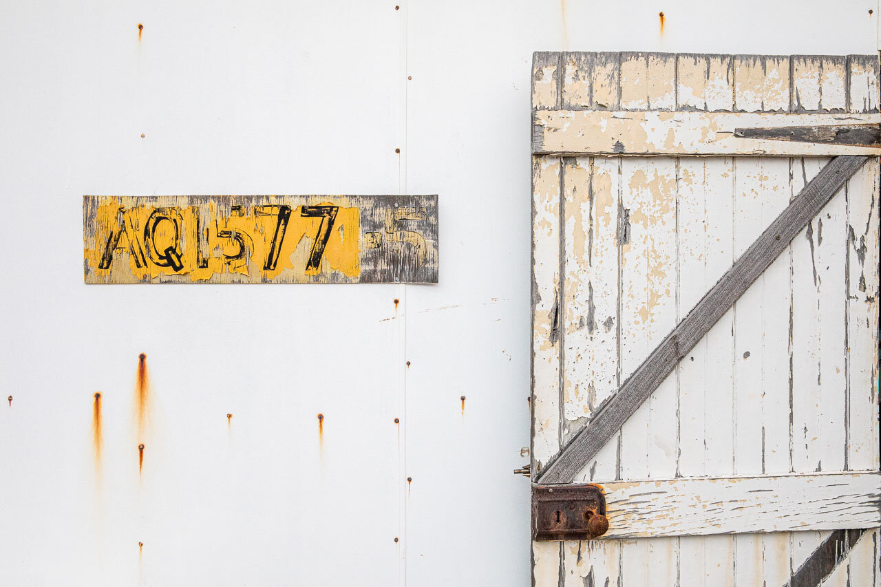 Minimalist shack with old wooden door and licence number relating to crawfishing