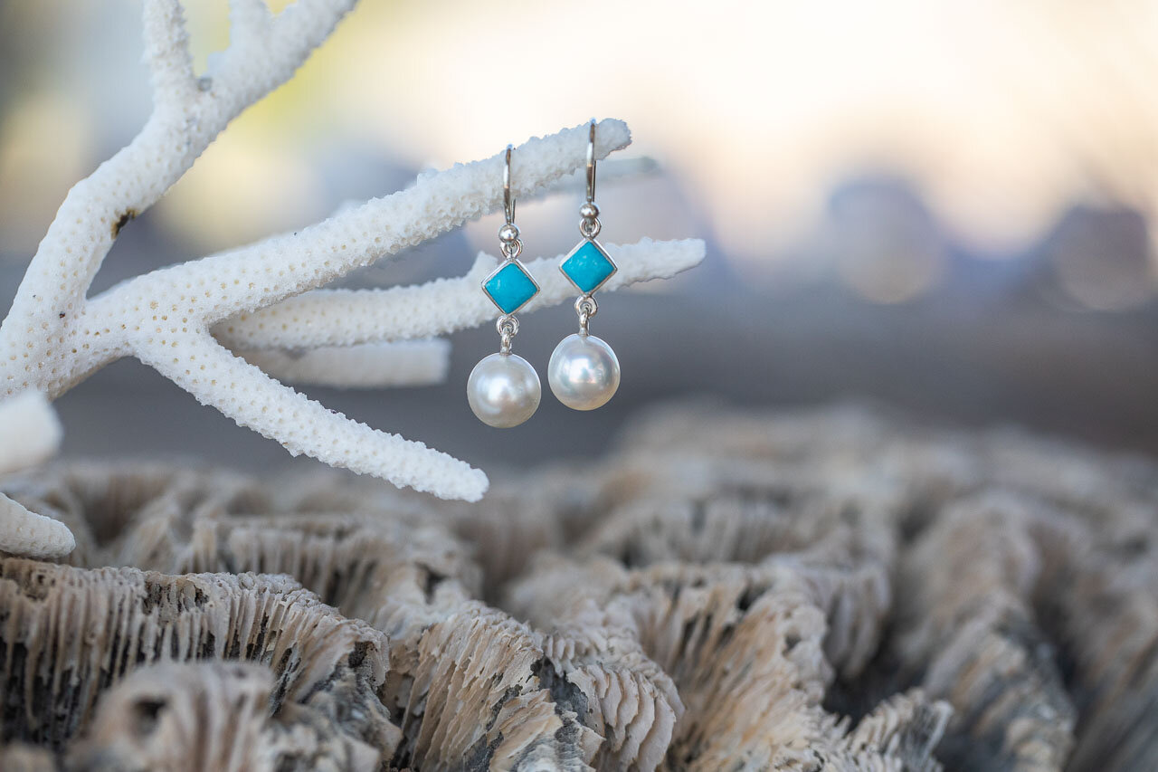 Dog Rock Jewellery's pearl earrings photographed on coral