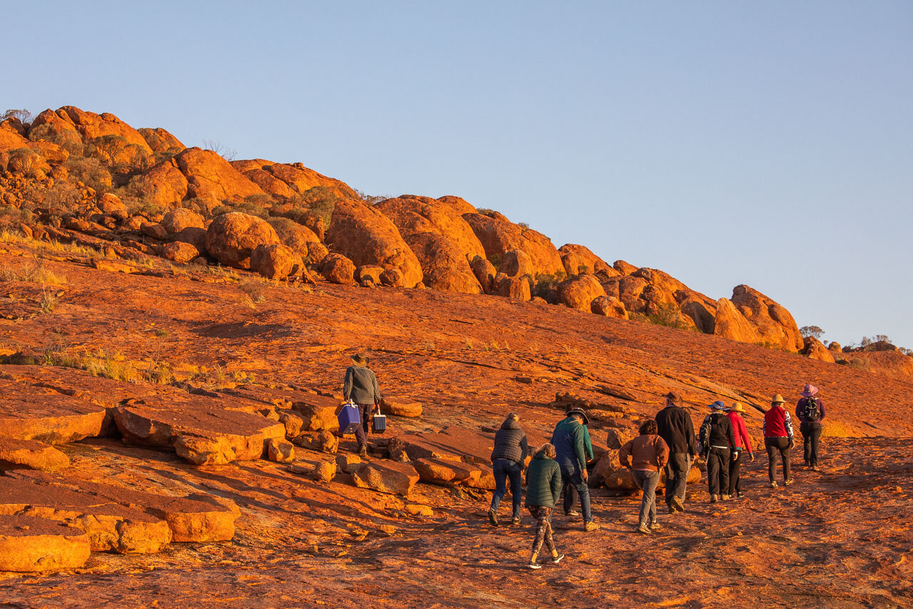 David Pollock leads Wooleen Station's guests up Budara Rock to enjoy a wine and watch the sunset.