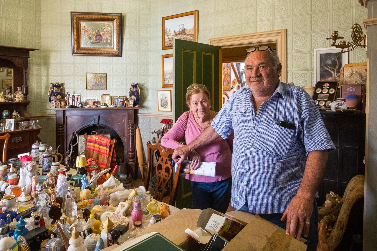 Dianne and Terry Demasson and their collection of Avon product packaging