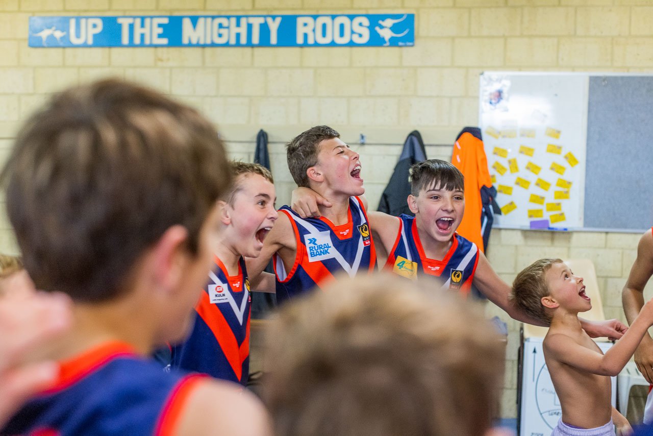 Kulin's junior footy team sing their club song in the changing rooms after winning their game.