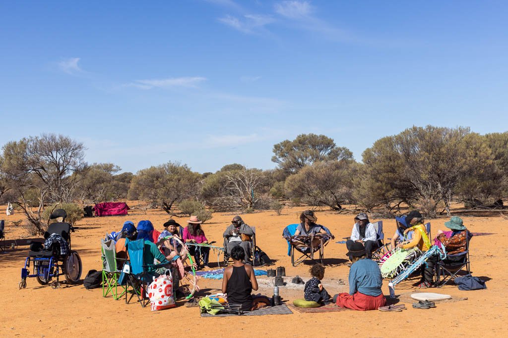 Local indigenous elders sharing stories as rugs are woven on the Reclaim the Void camp north of Leonora